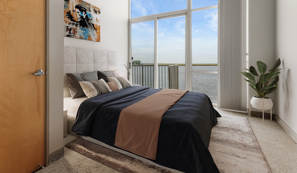 a bedroom with a large bed sitting next to a window