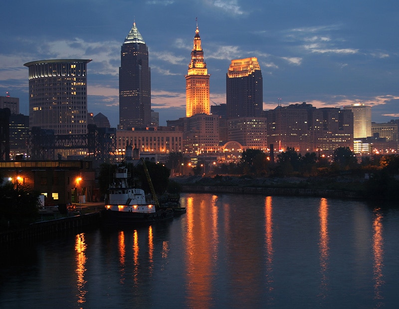 a large body of water with a city in the background